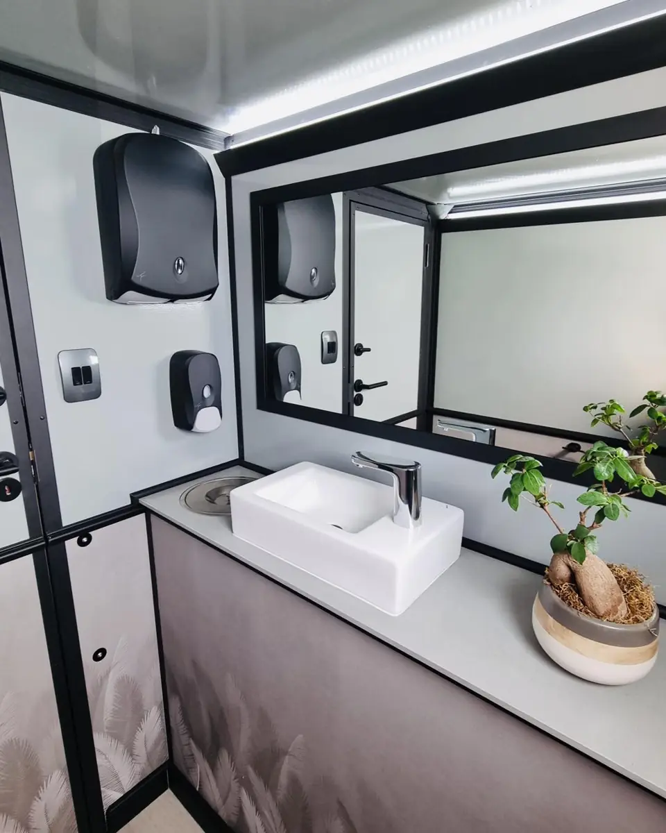 Sink and soap dispensers inside a wedding restroom trailer