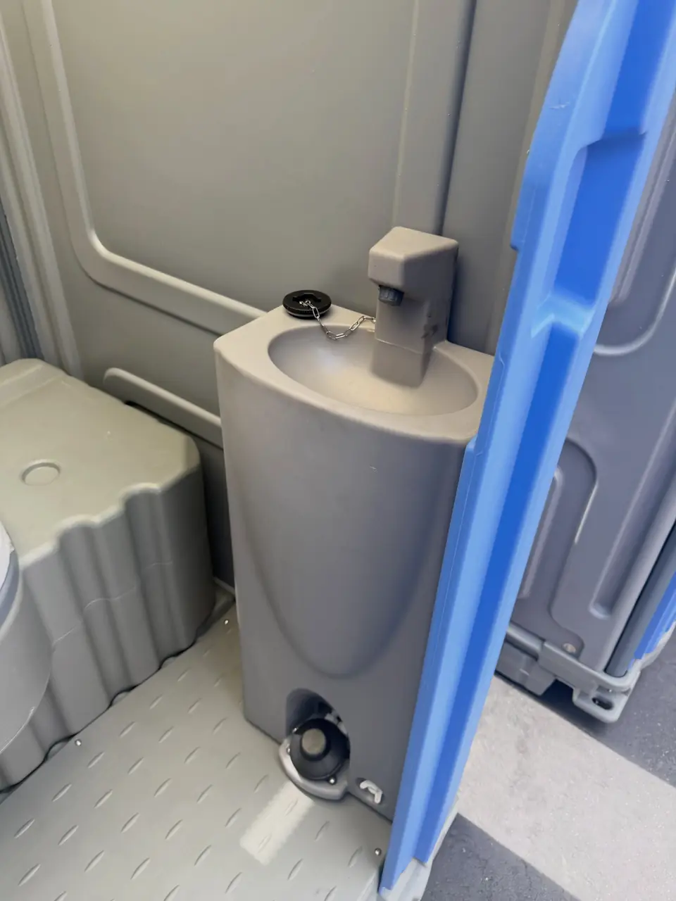 Hand-wash sink inside a porta potty unit